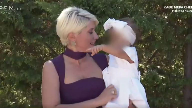 Σία Κοσιώνη: Νονά με midi στενό φόρεμα και... βοηθό τον γιο της Δήμο Μπακογιάννη